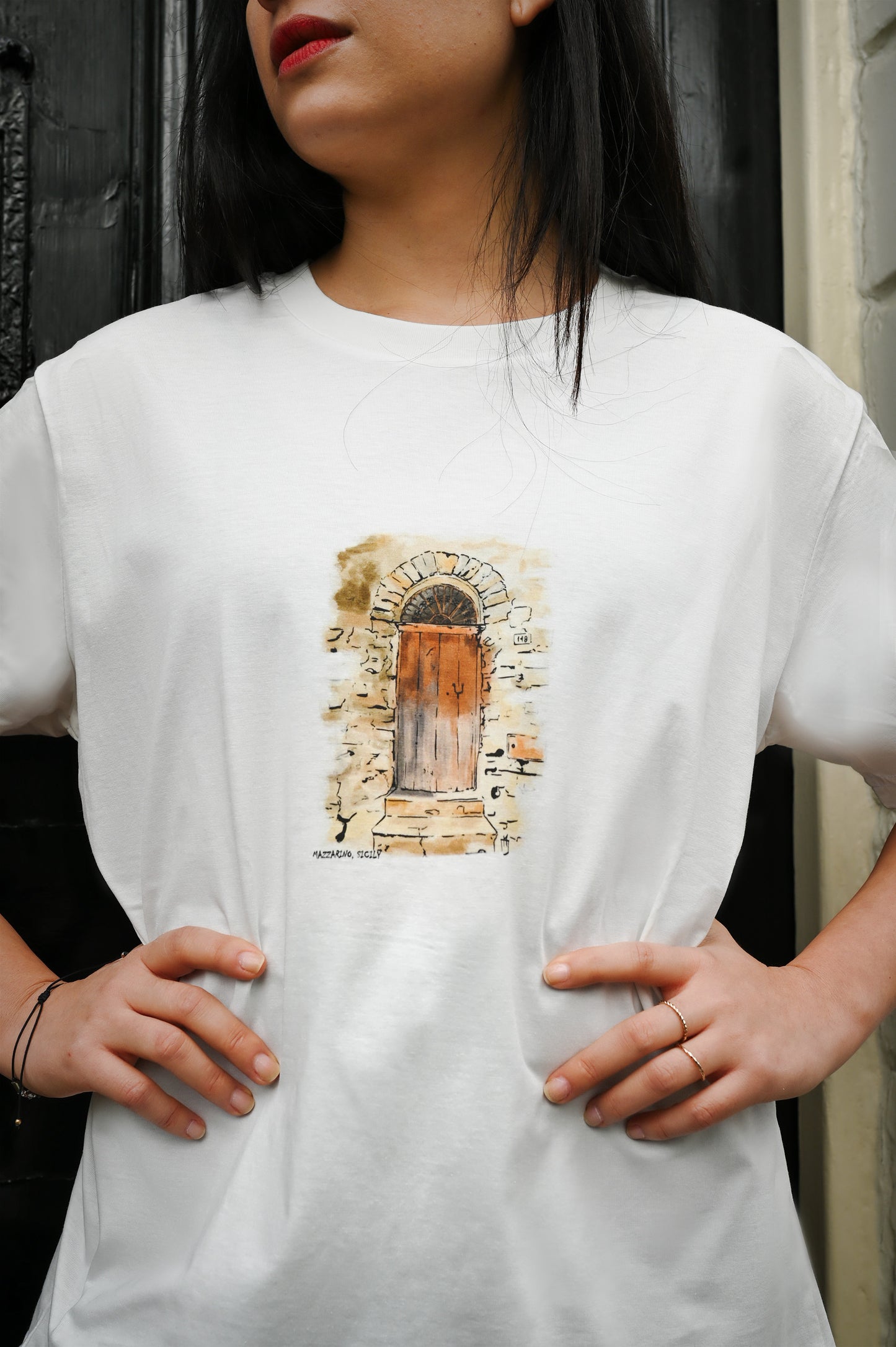 T-Shirt made from high-quality organic cotton, this unique hand-drawn illustration captures the essence of a 100-year-old door in a Sicilian village